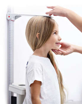 Girl having her height measured