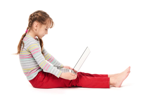 Girl sitting on the floor looking at a laptopasf