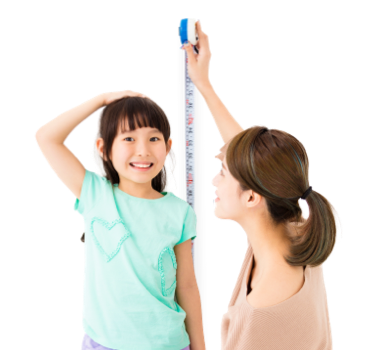 Mother measuring daughter's height